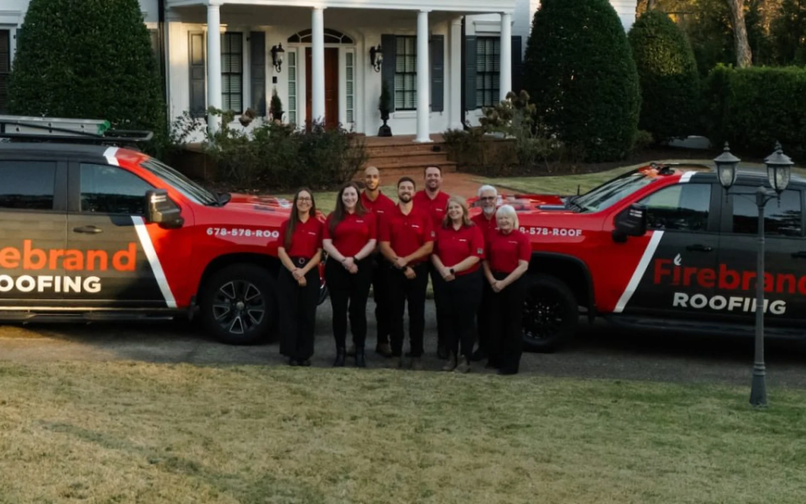 The Firebrand Roofing team with their trucks