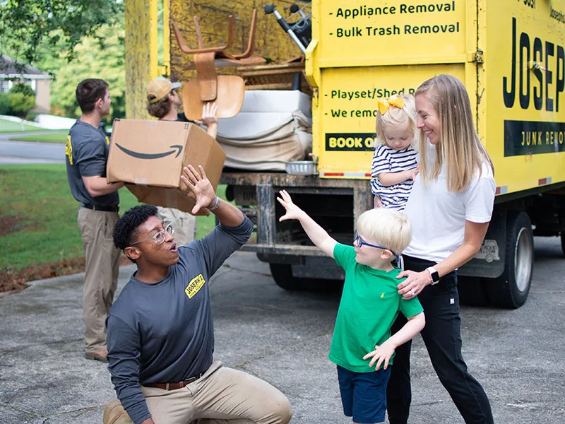 A Joseph's Junk Removal team member greeting a family at their home